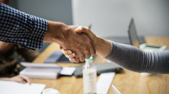 Handshake between two successful business people in the office